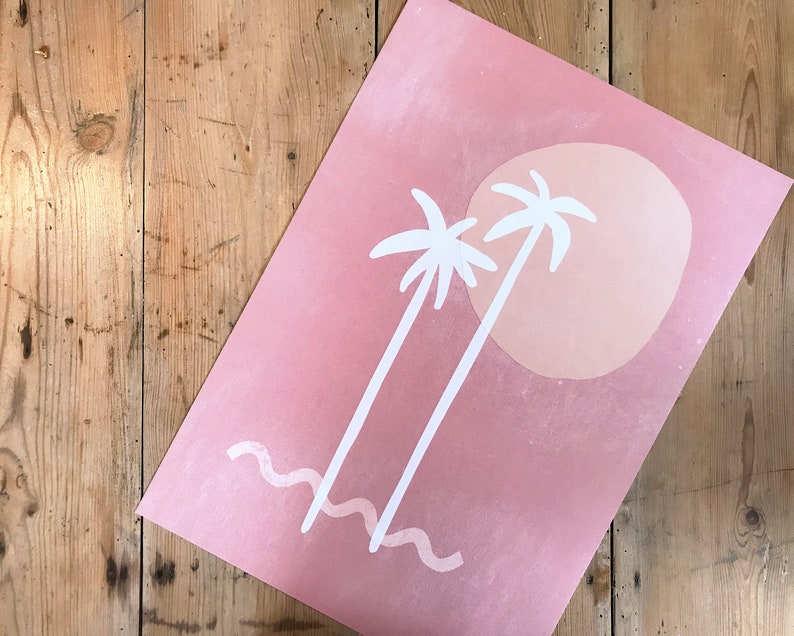 May include: A pink and white print with two palm trees and a large sun. The background is a light pink with a gradient to a darker pink at the top.