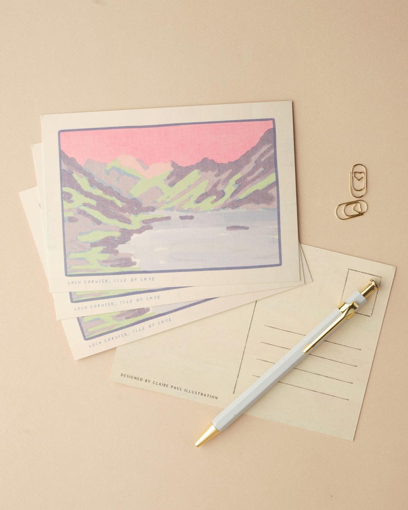 May include: A stack of postcards with a colorful illustration of a mountain range and a lake. The text on the postcard reads "Loch Crevier, Isle of Skye" and "Designed by Claire Paul Illustration".