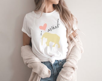 May include: A white t-shirt with a pink heart and the text "i love animals" in black. A yellow elephant silhouette is below the text.