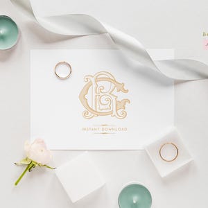 May include: A wedding invitation design featuring a monogram with the letters "CB" in a decorative font. The design is surrounded by wedding rings, candles, flowers, and a white ribbon. The words "Instant Download" are below the monogram.