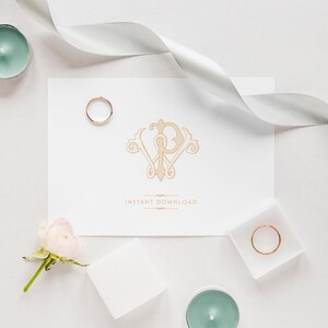 May include: A white card with a gold monogram of the letters "W" and "P" surrounded by decorative flourishes. The text "Instant Download" is printed below the monogram. The card is surrounded by white ribbon, two gold rings, and white roses.
