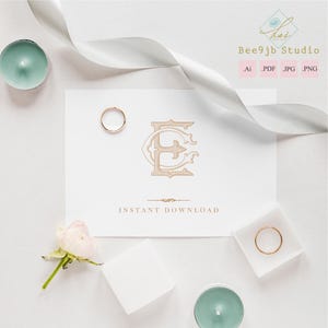 May include: A wedding invitation design featuring a gold monogram of the letters "E" and "C" on a white card. Two gold rings, a white ribbon, a small pink rose, and two teal candles are arranged around the card. The text "INSTANT DOWNLOAD" is below the monogram.