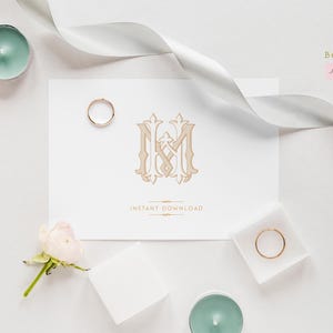 May include: A white card with a gold monogram of the letters "I" and "M" intertwined. The card is surrounded by white ribbon, gold rings, and white flowers. The text "INSTANT DOWNLOAD" is printed below the monogram.