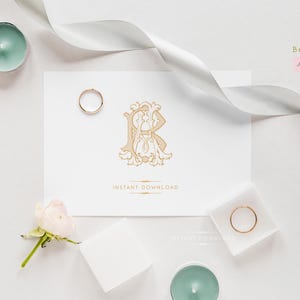 May include: A flat lay featuring a white card with a gold monogram and the words "INSTANT DOWNLOAD". Two gold rings, candles, flowers, and a white ribbon are arranged around the card. The Bee9jb Studio logo is in the upper right corner.