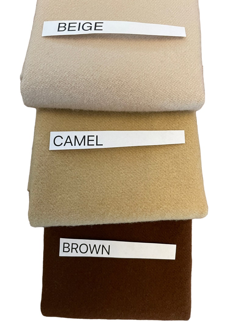 May include: Three fabric swatches in beige, camel, and brown. Each swatch has a label with its color name. The beige swatch is at the top, followed by camel, and brown at the bottom. The fabrics appear to be a soft, woven material.