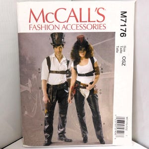 May include: McCall's Fashion Accessories sewing pattern M7176. The cover features two people in steampunk-inspired outfits. The man wears a top hat, white shirt, and black pants. The woman wears a similar outfit with a white top and curly hair.