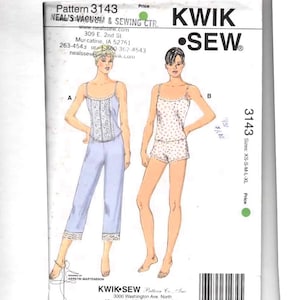 May include: Kwik Sew pattern 3143 envelope featuring illustrations of two sleepwear sets. View A shows a light blue camisole with lace trim and matching cropped pants. View B shows a floral print camisole and shorts set. Sizes XS-S-M-L-XL.