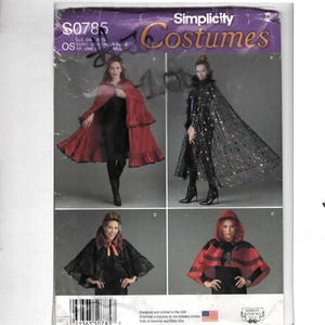 May include: A Simplicity Costumes sewing pattern envelope S0785 featuring four variations of capes and cloaks. The designs include a long red ruffled cape, a long black sheer cape with star patterns, a black capelet, and a red hooded capelet with black trim.