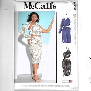 May include: McCall's sewing pattern M8331 featuring a woman wearing a white and gold floral print dress with a cutout design. The pattern includes multiple view options and is designed and printed in the USA.