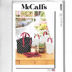 May include: McCall's sewing pattern featuring various tote bags and containers. The bags are black with white polka dots and red handles. The pattern includes instructions for different sizes and styles of bags.