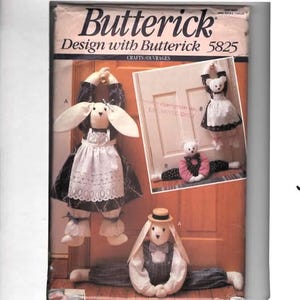 May include: Butterick pattern 5825 features designs for decorative bunny and bear crafts. The image shows several finished plush figures, including a bunny with a bonnet and a bear in a dress. The pattern includes instructions for making these charming, handcrafted items.