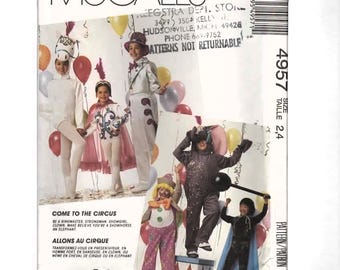 May include: McCall's sewing pattern for children's circus costumes. The pattern includes designs for a ringmaster, strongman, showgirl, clown, showhorse, and elephant. The image shows children in the costumes with balloons.