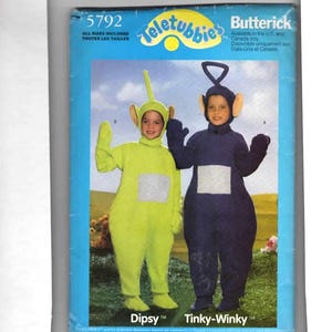 May include: A Butterick pattern package featuring two children in Teletubbies costumes. One child is in a lime green Dipsy costume, and the other is in a navy blue Tinky-Winky costume. The package includes the text "5792" and "All Sizes Included".