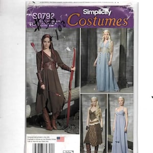 May include: A Simplicity Costumes sewing pattern envelope S0792 featuring four fantasy-inspired outfits. The images display a brown dress with a bow and arrow, a long blue gown, a brown two-piece set with a skirt, and a long blue sleeveless dress.