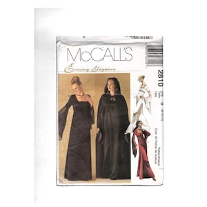 May include: A McCall's Evening Elegance sewing pattern envelope, number 2810, size B (8-10-12). The front displays illustrations of long black dresses with flared sleeves and a hooded cloak with purple lining, alongside a white and a red dress version.