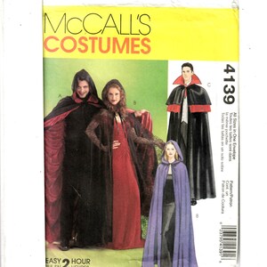 May include: McCall's Costumes sewing pattern number 4139 for a vampire costume. The pattern includes three different styles of capes: a black cape with red lining, a black cape with a hood, and a purple cape with a hood. The pattern is easy to sew and can be completed in two hours.