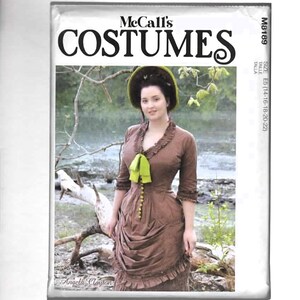 May include: McCall's Costumes pattern featuring a woman in a brown Victorian-era dress with a green bow and hat. The pattern cover includes the designer's name, Angela Clayton, and size information.