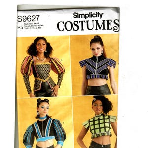 May include: Simplicity Costumes sewing pattern number S9627 for sizes US 14-22, Talla Euro 40-48, Taille FR 42-50. The pattern includes four different crop top designs with various embellishments and sleeve styles.