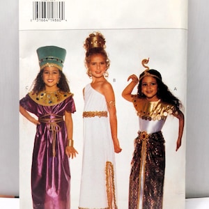 May include: Butterick pattern 3586 featuring children's costumes. The costumes include an Egyptian pharaoh, a Greek goddess, and an Egyptian queen. The pattern includes all sizes. The costumes are in purple, white, and gold.