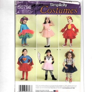 May include: A Simplicity Costumes sewing pattern envelope S0796 for sizes 1/2-4, featuring illustrations of six different children's costumes including a fairy, a princess, a bird, a superhero, a pirate, and a clown with a top hat.