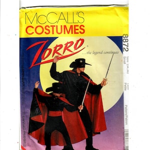 May include: A sewing pattern for a Zorro costume. The pattern is for a small size and includes a black shirt, pants, and a red cape. The pattern is from McCall's Costumes and features the text "Zorro...the legend continues".
