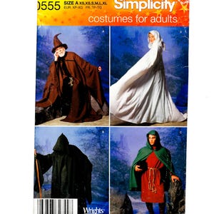 May include: Simplicity costume pattern 0555 for adults. The pattern features four costume designs: a brown wizard robe, a white hooded cloak, a black hooded robe, and a green cape with a red tunic.