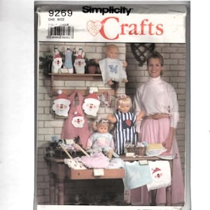 May include: A Simplicity Crafts pattern envelope, number 9269, featuring illustrations of various handmade items including dolls, bibs, and aprons with Santa Claus motifs. The packaging displays the brand name, pattern number, and a barcode.