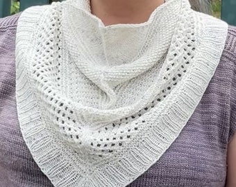 May include: A white crocheted cowl with a lacy pattern. The cowl is folded in half and draped over a person's shoulders.