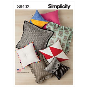 May include: Simplicity sewing pattern S9402 for making pillows. The pattern includes instructions for making six different pillows with various designs and embellishments, including a black and white geometric pillow, a white pillow with a button, a red and white geometric pillow, a black and white geometric pillow with a button, a brown and white floral pillow with ruffles, and a green pillow with a cat print and ruffles.