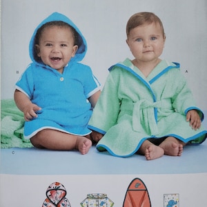 May include: Simplicity sewing pattern number S9483 for making baby robes and hooded towels. The pattern includes instructions for making a blue hooded robe, a green hooded robe, a pink hooded robe, a white and blue hooded robe, and a red hooded towel. The pattern also includes a small illustration of a hooded towel with an elephant design.
