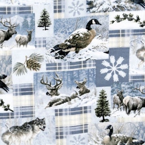 May include: Winter-themed fabric with a patchwork design. The fabric features illustrations of deer, wolves, geese, pine trees, and snowflakes set against a backdrop of blue and white plaid squares. The overall theme is a winter forest scene.