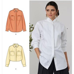 May include: Simplicity sewing pattern S3232. The image shows a woman wearing a white button-down shirt. The pattern includes illustrations of a striped orange shirt, a yellow cropped shirt, and the text "Designed and printed in USA."