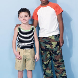 May include: Two young boys wearing casual clothing. The boy on the left is wearing a striped tank top, khaki cargo shorts, and blue sneakers. The boy on the right is wearing a white and orange baseball tee shirt, camouflage pants, and black and white sneakers.
