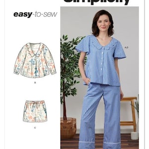 May include: Simplicity sewing pattern S3240. The image shows a woman wearing a blue and white gingham pajama set. The pattern includes a top, shorts, and pants. The top has a scalloped collar and the pants have a scalloped hem.