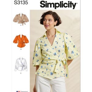 May include: Simplicity sewing pattern S3135. The image shows a woman wearing a yellow wrap top with blue floral print. The pattern includes illustrations of wrap tops with different sleeve styles. The text "Designed and printed in USA" is visible.