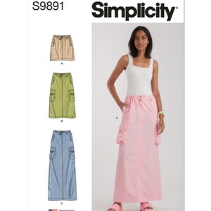 May include: Simplicity sewing pattern S9891 for a long skirt with pockets. The pattern includes three variations: a short skirt with a plaid pattern, a knee-length skirt with a green solid color, and a long skirt with a light blue solid color. The pattern is designed and printed in the USA.