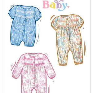 May include: Simplicity Baby pattern S3242 features three baby romper designs. One is light blue with a floral print, another is a woodland animal print, and the third is pink with a floral pattern. Each has lace trim and button closures.