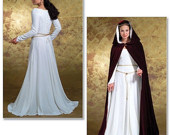 May include: A white medieval-style gown with long sleeves and a fitted bodice. The gown has a lace-up back and a sash tied at the waist. The model is also wearing a burgundy velvet cape with a hood.