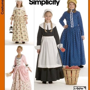 May include: Simplicity sewing pattern for three children's costumes. The pattern includes a colonial dress with a floral print, a pilgrim dress with a black bodice and white apron, and a colonial dress with a blue and white polka dot print. The pattern is for sizes 6-14.