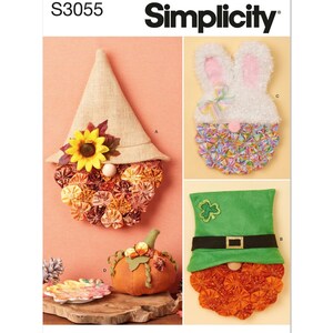 May include: A Simplicity sewing pattern, S3055, for making three different gnome-themed decorations. The decorations include a fall gnome with a sunflower, a leprechaun gnome with a green hat, and an Easter bunny gnome with white fur.