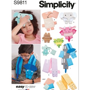 May include: A sewing pattern for making stuffed animal toys. The pattern includes instructions for making a dragon, an elephant, a bear, and a dinosaur. The pattern is called "Simplicity S9811 easy-to-sew".