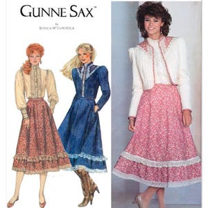 May include: Simplicity sewing pattern S3214 featuring Gunne Sax designs. The image shows illustrations of vintage dresses, including a pink floral skirt and a blue denim dress. The pattern is designed and printed in the USA.