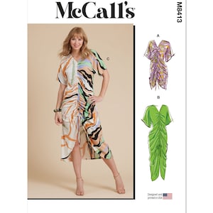 May include: McCall's sewing pattern M8413 for a dress with a gathered bodice and a V-neck. The pattern includes three variations: a short-sleeved dress with a colorful abstract print, a short-sleeved dress in a solid purple, and a short-sleeved dress in a solid green.