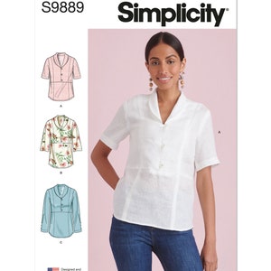 May include: Simplicity sewing pattern S9889 for a collared blouse with short sleeves. The pattern includes three variations: a pink blouse, a floral blouse, and a light blue blouse. The model is wearing a white version of the blouse with jeans.