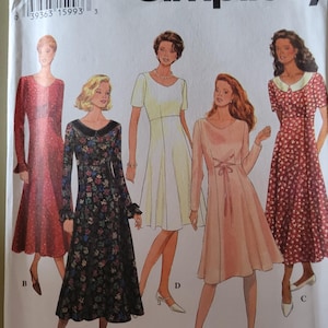 May include: A Simplicity sewing pattern envelope labeled 9198, size H 6, 8, 10. The front displays five illustrations of dresses with varying sleeve lengths, necklines, and floral or solid fabric patterns, labeled with letters A, B, C, and D.