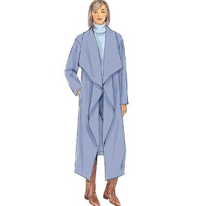 May include: A long, light blue coat with a draped collar and a high neckline. The coat is worn over a light blue turtleneck sweater.