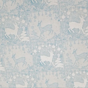 May include: A repeating pattern of white reindeer, Christmas trees, and ornaments on a light blue background. The design has a vintage, textured appearance, creating a festive holiday theme.