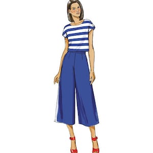 May include: A woman is wearing a blue and white striped short-sleeved top with a blue pair of wide-leg cropped pants.