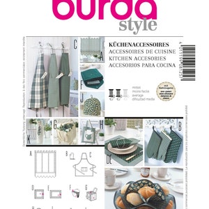 May include: A magazine cover with the text "burda style" and the number "8125". The cover features various kitchen accessories, including aprons, oven mitts, placemats, and a bread basket, all in green and white patterns.