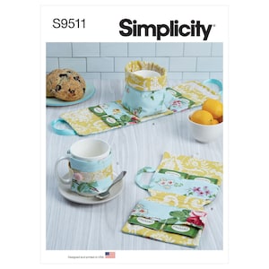 May include: Simplicity sewing pattern S9511 for making tea cozy, tea bag holder, and mug cozy. The pattern features a yellow and blue floral fabric with a teacup and teapot design. The pattern is designed and printed in the USA.